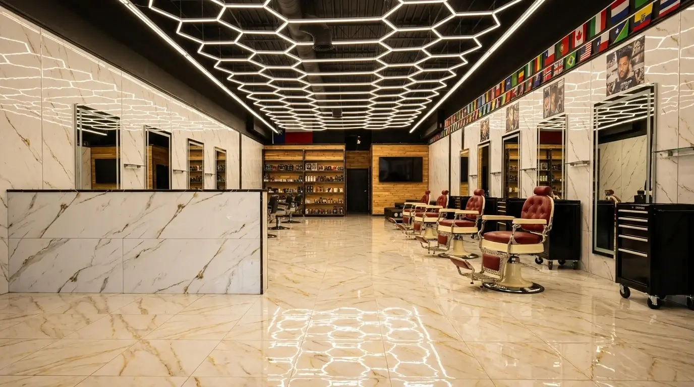 Inside the EverCutz barbershop in Richardson, TX: hexagon light ceiling, marble floor and red barber chairs