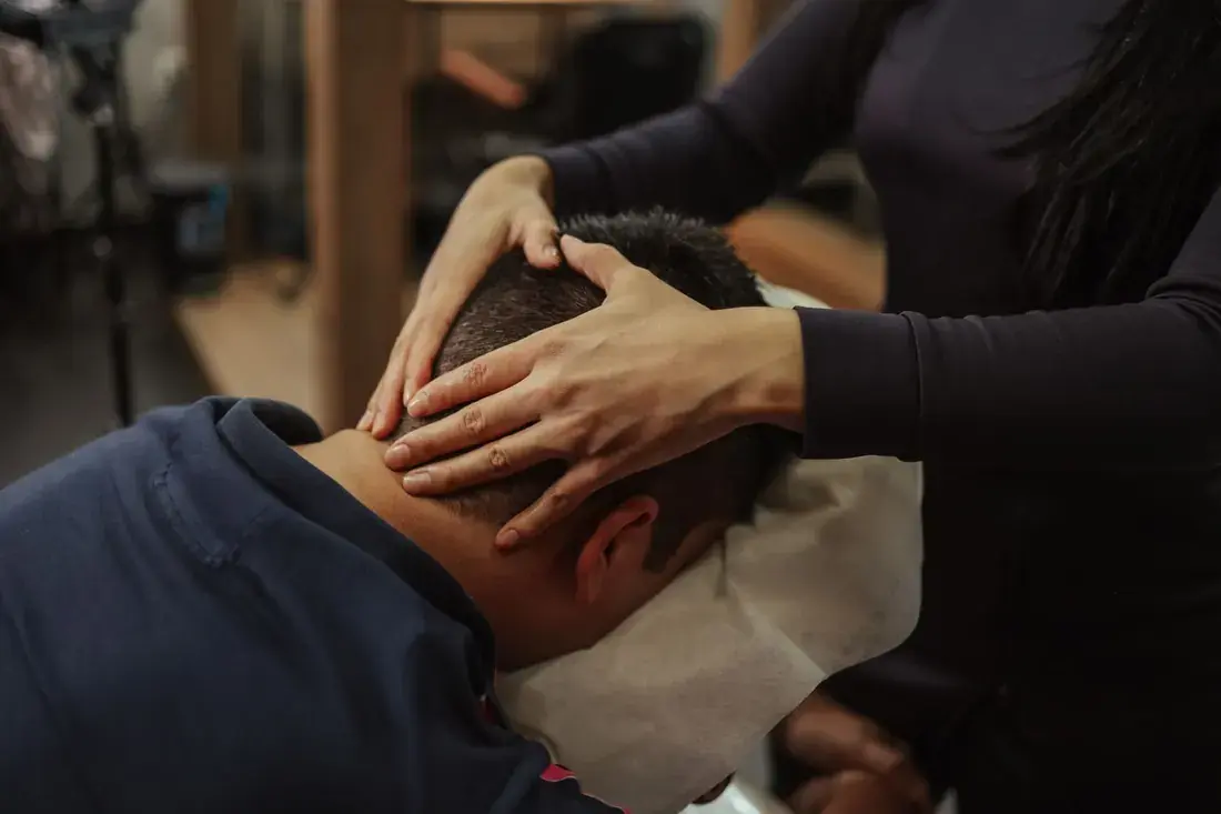 A guest getting a relaxing head massage in the chair