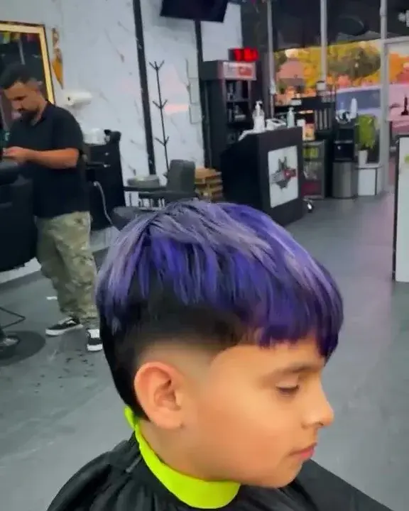 Boy’s crop with purple color and a low fade, done at EverCutz