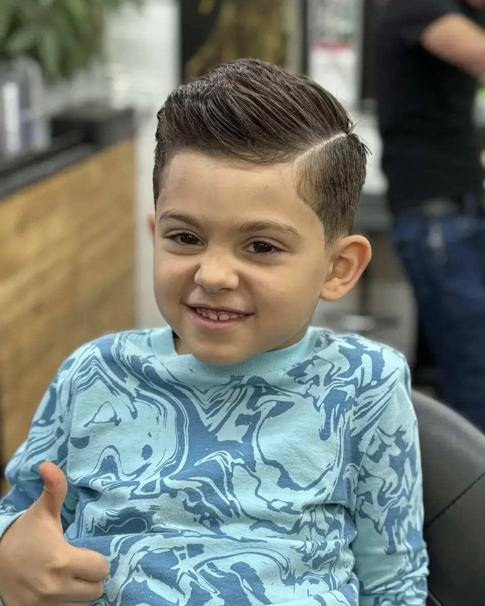 A boy giving a thumbs up after his haircut at EverCutz