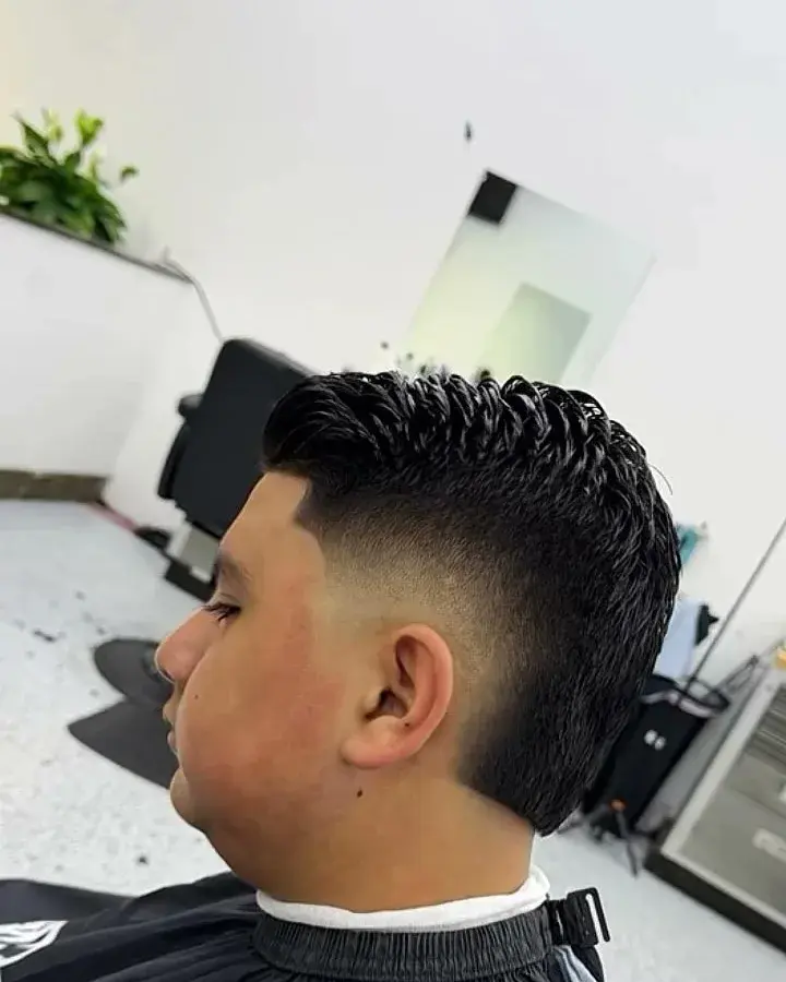 Low taper fade with a textured top, cut at EverCutz